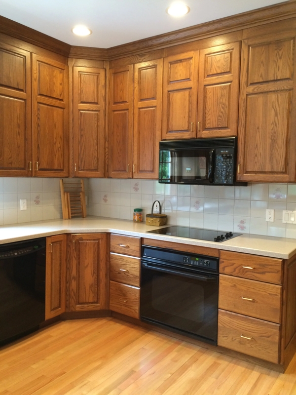 Traditional Raised Panel Cabinetry with Black Appliance Contrast