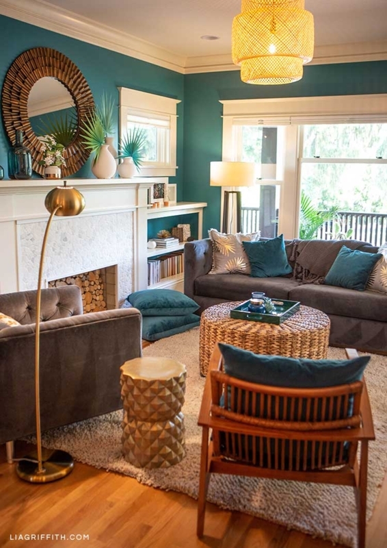 Tropical Chic Living Room with Teal Walls and Gold Accents