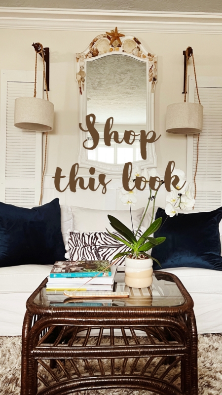 Tropical Coastal Living Room Scene with Shell Mirror and Dark Rattan Table