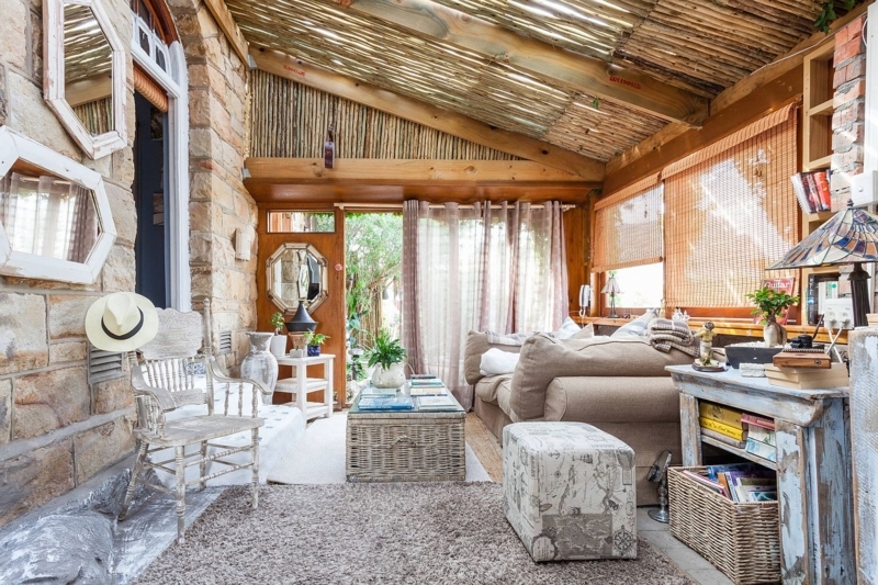 Tropical Rustic Sunroom Lounge with Reed Thatch Ceiling and Stone Walls