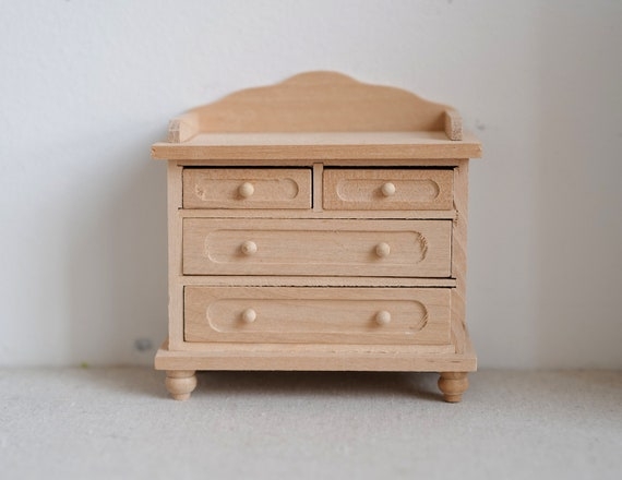 Unfinished miniature dresser with bun feet and curved backsplash