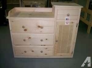 Unfinished wooden changing table with split level top and cabinet