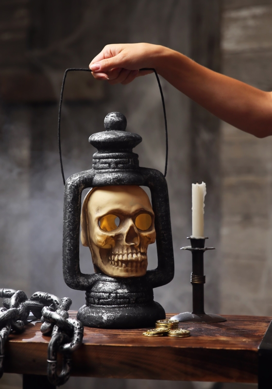 Weathered Decorative Lantern with Glowing Skull Eyes