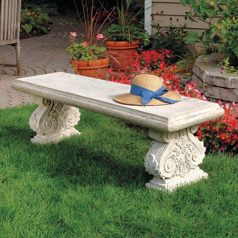 Weathered Garden Bench with Ornate Scroll Pedestals