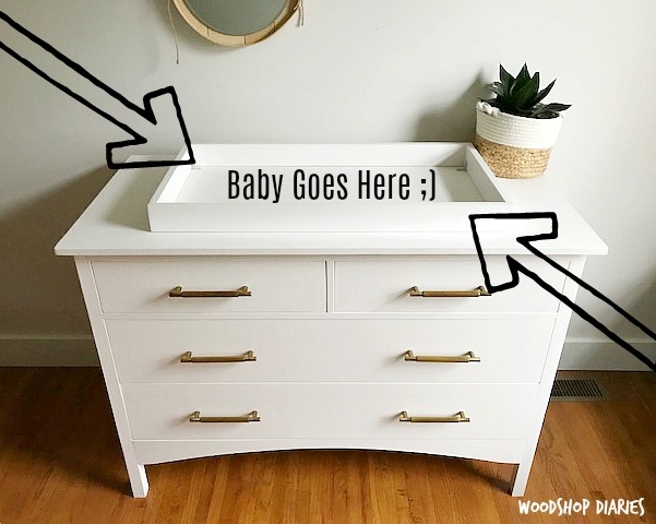 White nursery dresser topper with curved apron and brass bar pulls