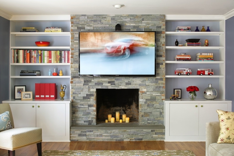 White Symmetrical Built-In Shelving with Blue Backing and Stone Fireplace