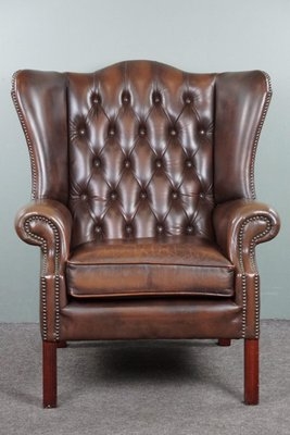 Wingback Armchair: Aged Cognac Leather Patina with Nailhead Trim