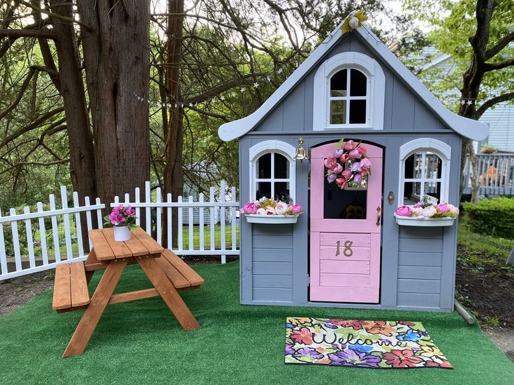 Grey Cottage Playhouse with Pink Accent Door and Scalloped Roofline