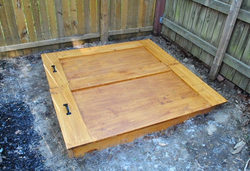 Honey Brown Folding Lid Sandbox featuring Black Metal Handles