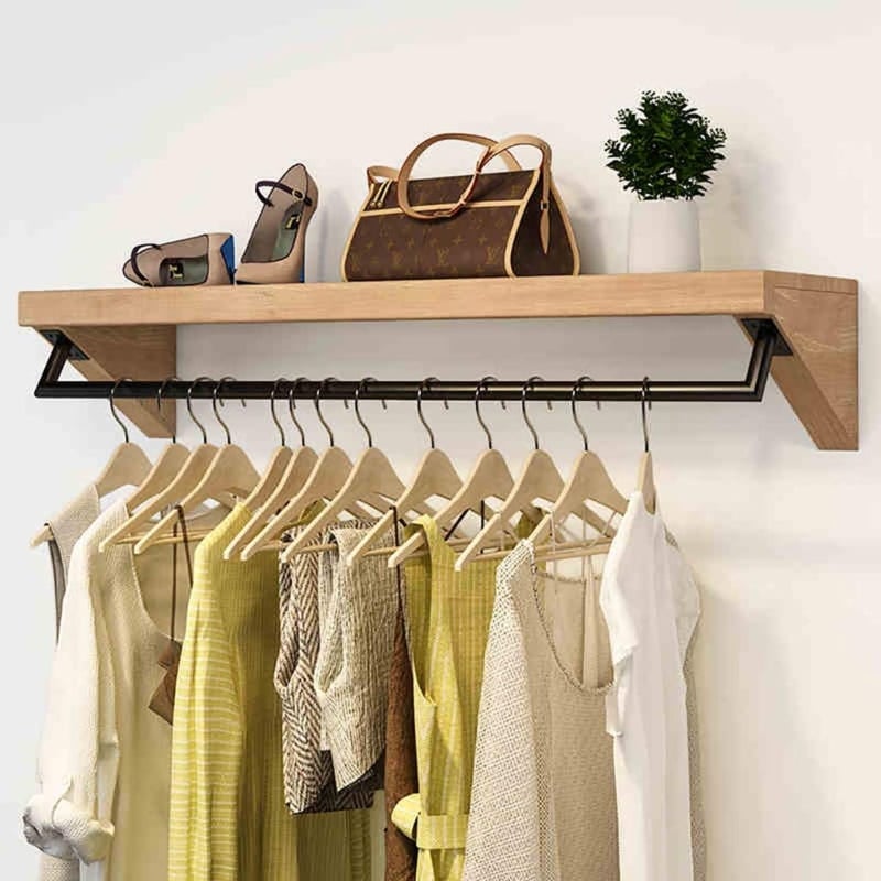 Wall Mounted Clothing Rack with Angled Supports and Top Display Ledge