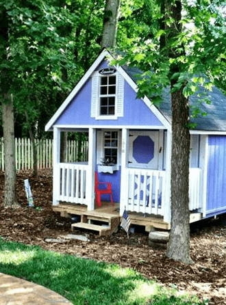 Whimsical Lavender Playhouse with White Picket Railing and Gable Window
