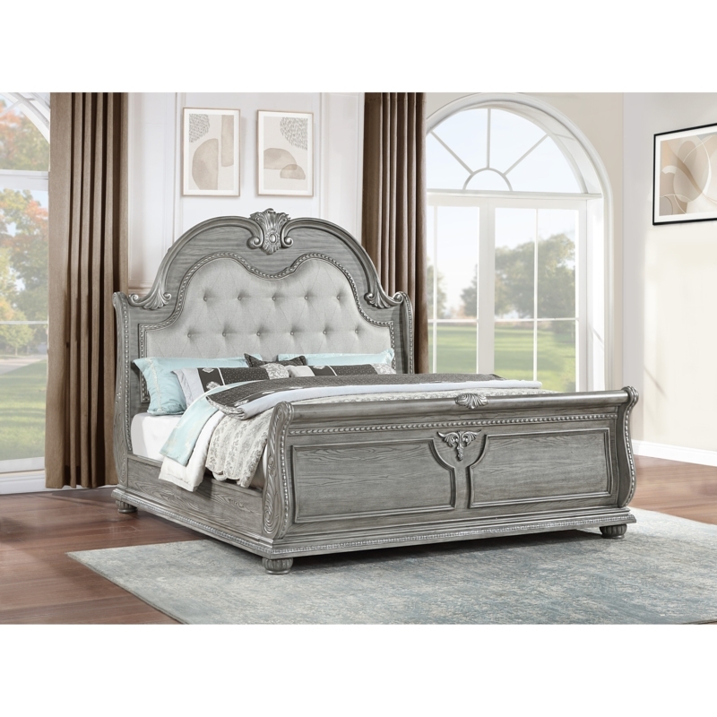 Arched Grey Sleigh Bed with Tufted Upholstery and Carved Details