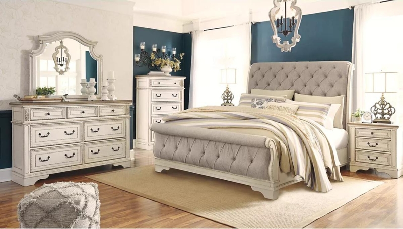 Chipped White Sleigh Bedroom Set against a Bold Teal Accent Wall