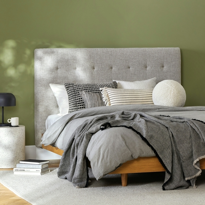 Headboard in Ivory Tufted Fabric against Olive Green