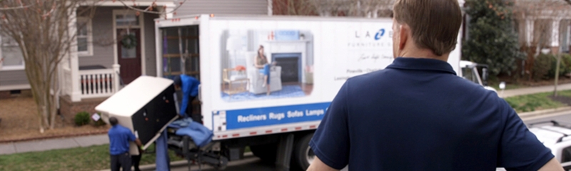 Professional Upholstered Furniture Delivery Service Scene with Movers