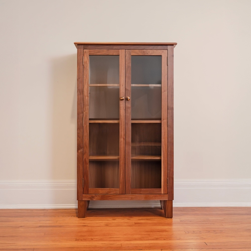 Slender Wood Bookcase with Full-Length Glass Doors and Tapered Legs