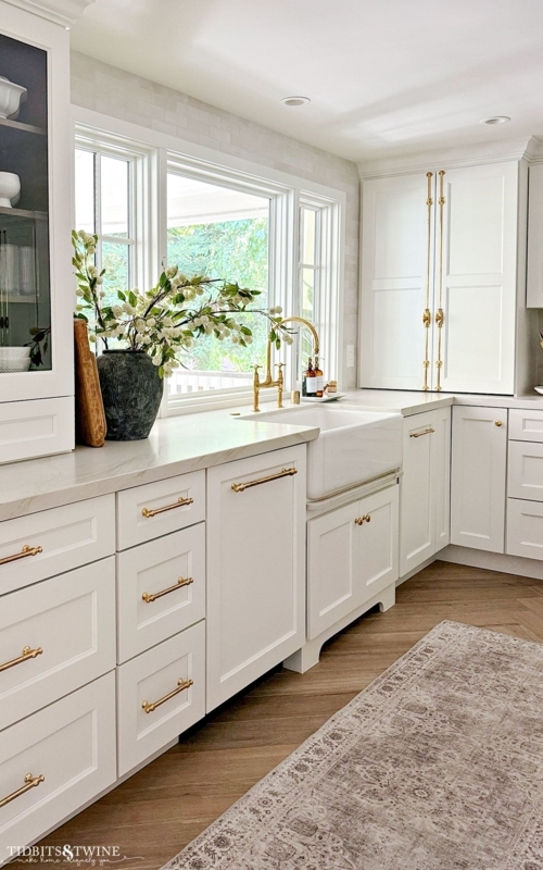 Warm White Kitchen Design with Herringbone Wood Floors