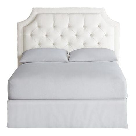 White Tufted Headboard with Elegant Shaped Silhouette and Piping