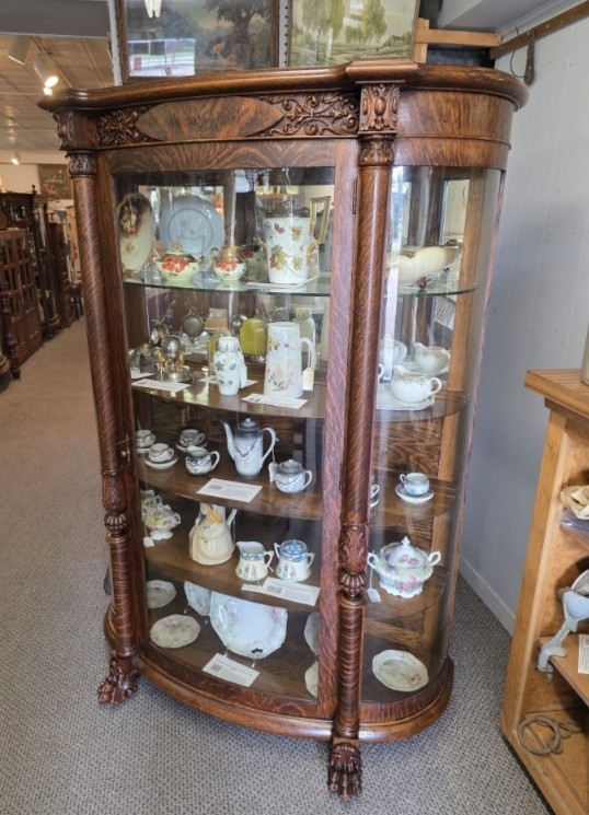 Antique Curio Cabinet with Curved Glass, Claw Feet, and Carvings