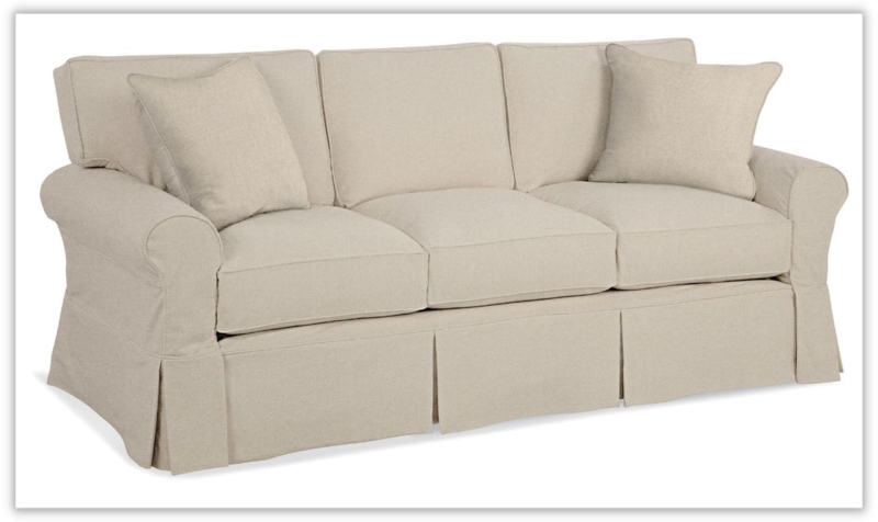 Beige Slipcovered Sofa featuring Kick Pleat Skirt and Rolled Arms