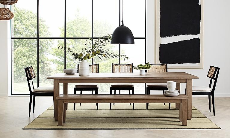 Dining Room with Cane-Back Chairs and Large Black Pendant
