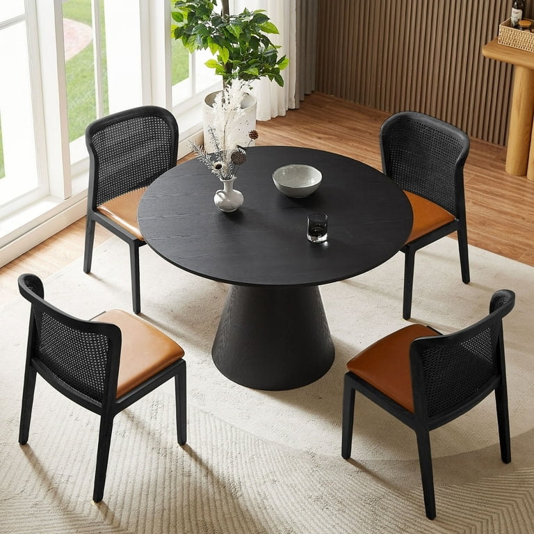 Dining Table with Conical Pedestal Base and Woven Back Chairs.