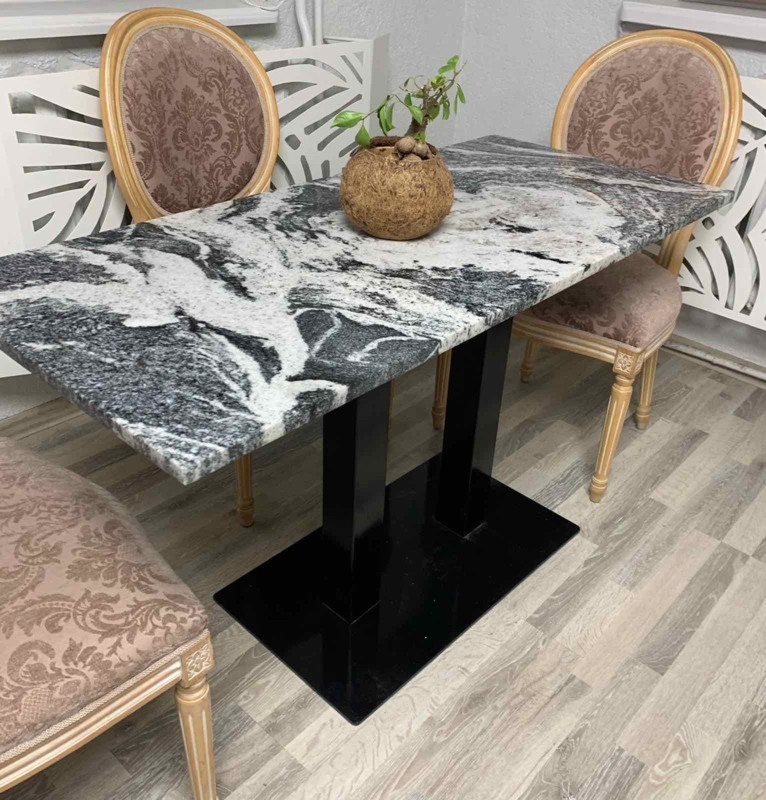 Dramatic Black and White Stone Dining Table with Twin Pillars