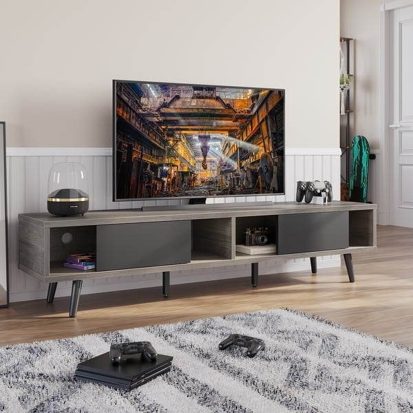 Entertainment center with sliding doors in grey wood finish.