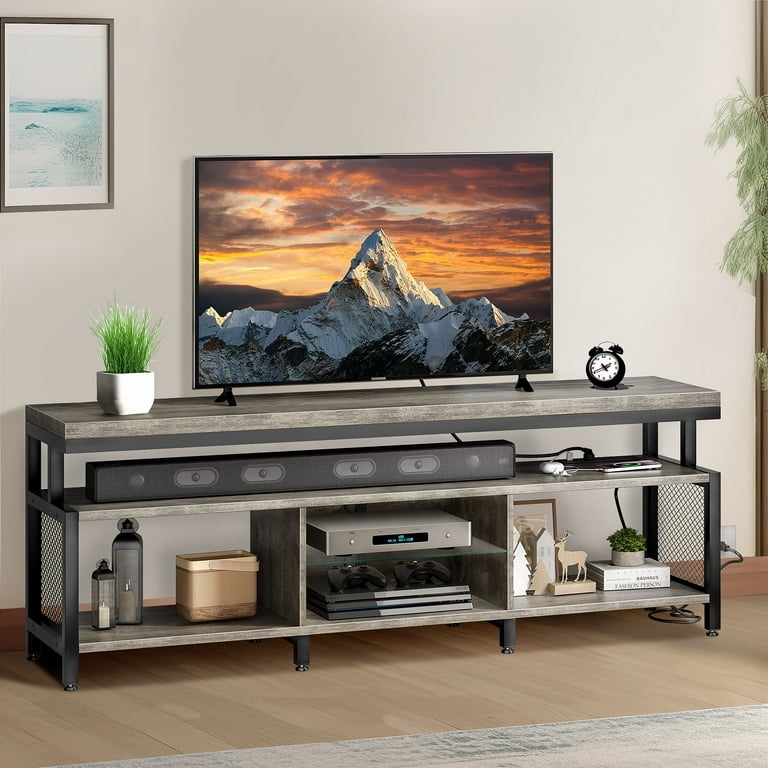 Gray wood entertainment center with mesh sides and power.