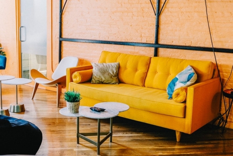 Industrial Style Sofa with Tufted Back, Bolster Pillows, and Tapered Legs
