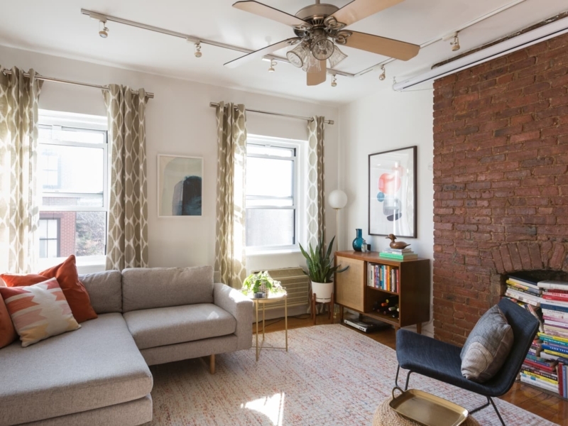 L-Shaped Sectional Sofa in Exposed Brick & Mid-Century Living Room