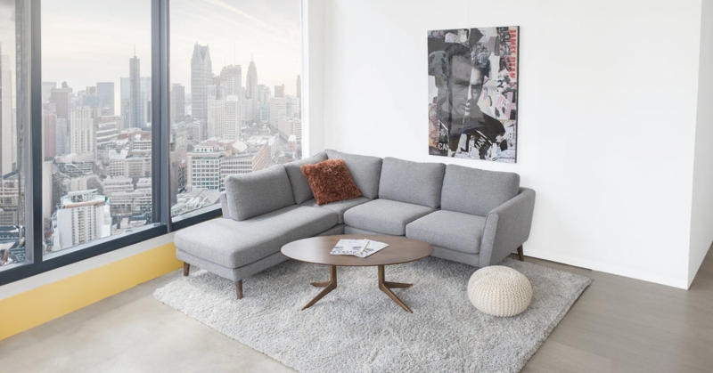 L-Shaped Sectional Sofa with Tapered Legs & Urban Skyline View