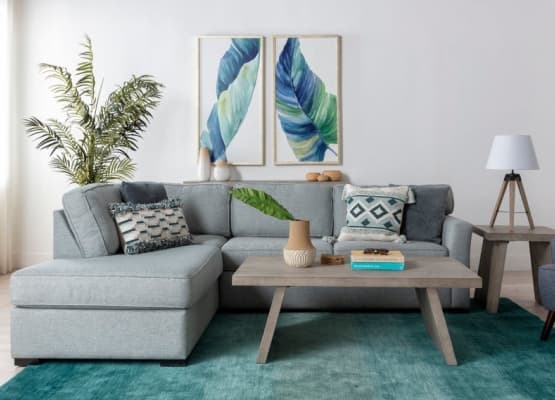 Light Gray Chaise Sectional Sofa with Teal Area Rug & Botanical Art