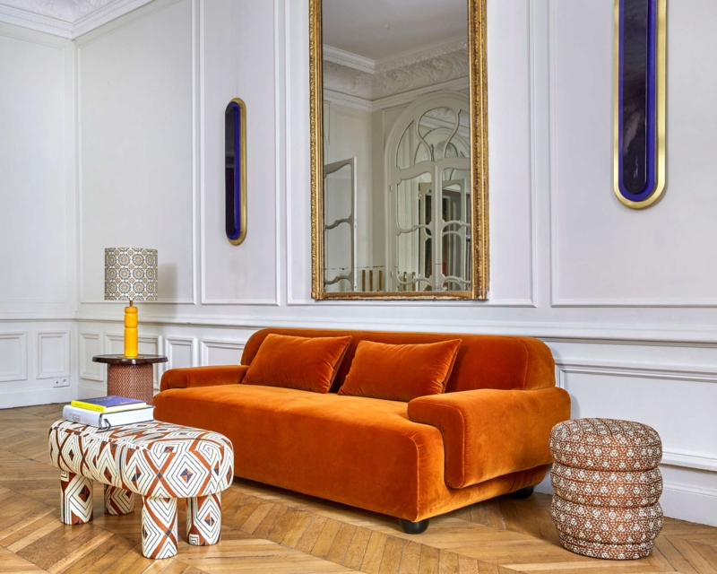 Low-Profile Orange Velvet Sofa in Maximalist Living Room