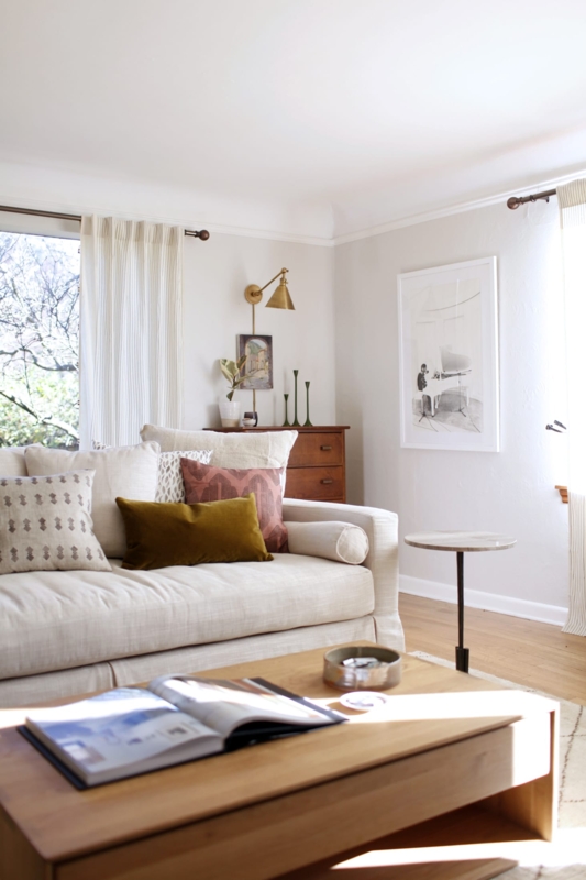 Neutral Skirted Sofa Living Room with Mustard Velvet Pillows