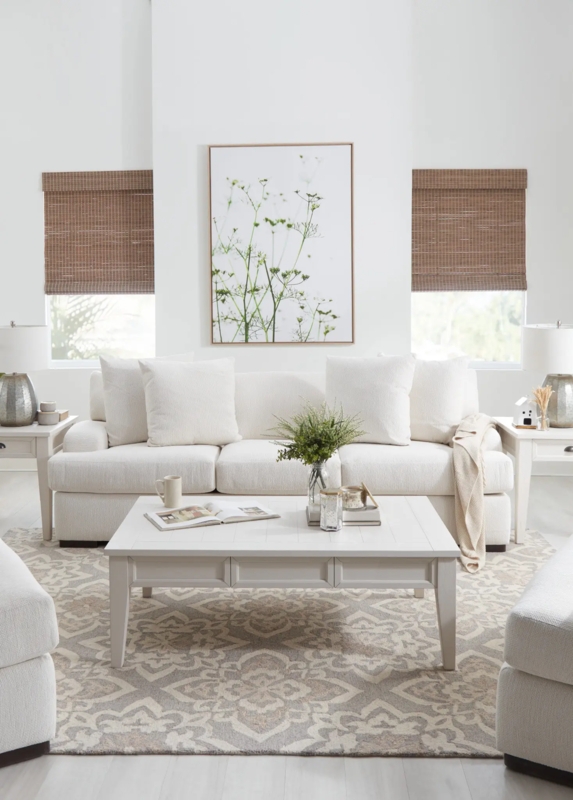 Off-White Fabric Sofa with Woven Bamboo Shades and Medallion Rug