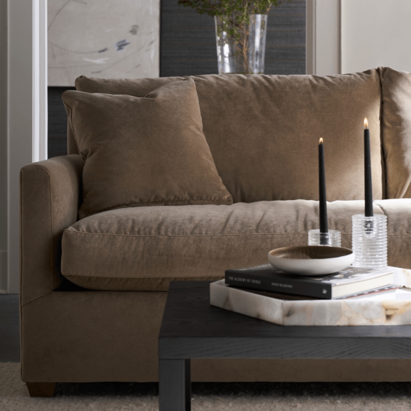 Plush Sofa with Moody Candlelight Decor and Ribbed Glass Holders