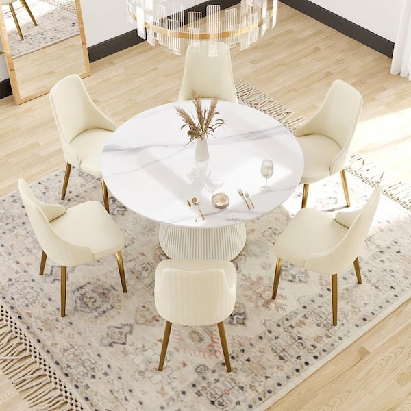 Ribbed Pedestal Dining Table with Stone-Like Top and Cream Chairs