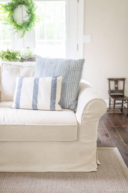 Rolled Arm Sofa with Deep Seating and Blue Striped Throw Pillows