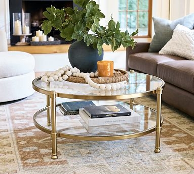 Round Coffee Table featuring Two Glass Tiers and a Brass Toned Frame