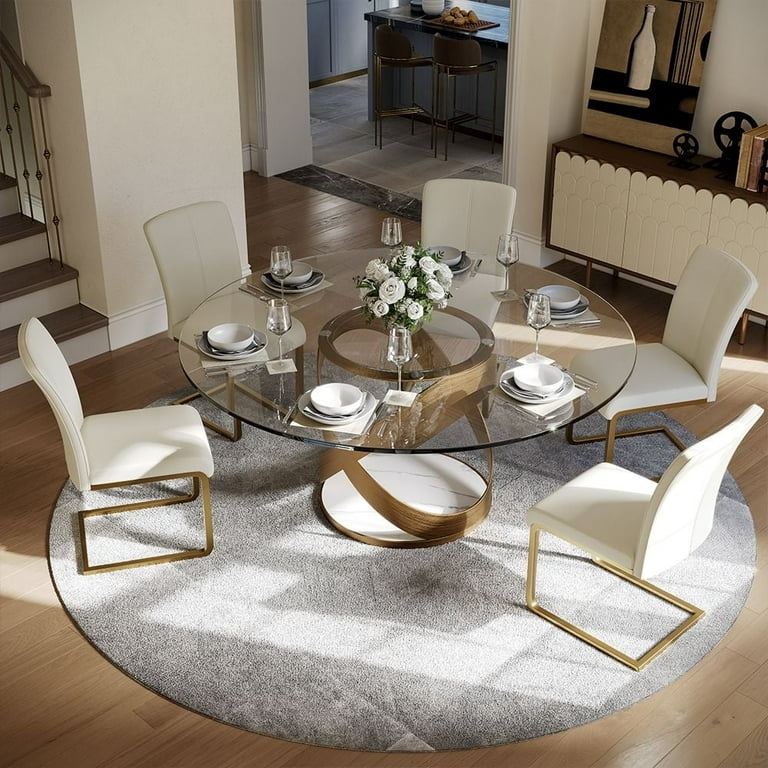 Round Dining Table: Sculptural Gold Base, White Sled Chairs
