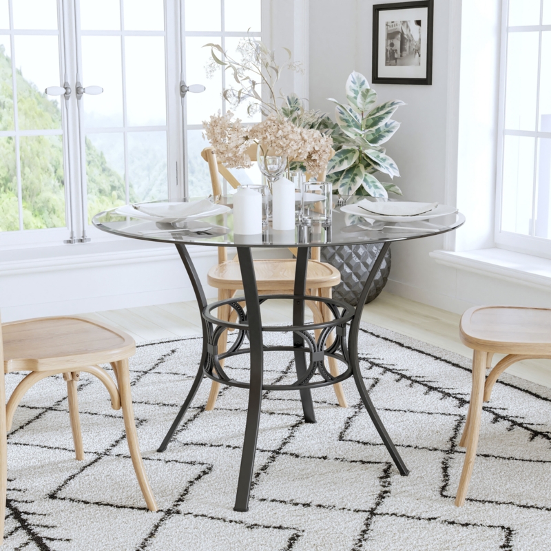 Round Dining Table with Black Metal Base and Circular Ring Motif