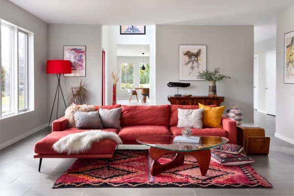 Sectional Sofa styled with Sculptural Glass Coffee Table & Geometric Rug