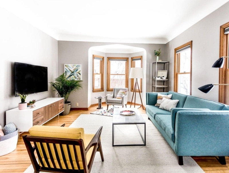 Sectional Sofa with Tapered Legs & Gallery Wall Backdrop Styling.