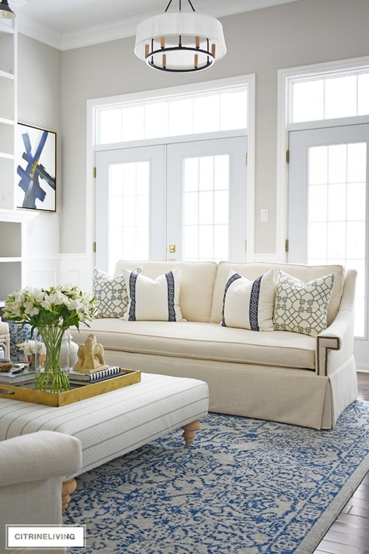 Skirted Sofa with Nailhead Trim and Blue Vintage Area Rug Style