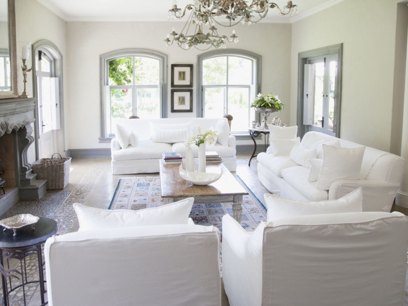 Slipcovered Sofa in a French Country Living Room with Arched Trim