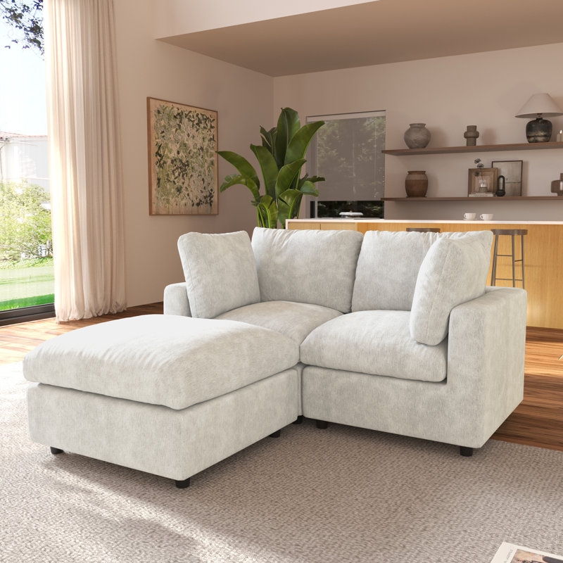 Small Off-White Sectional with Plush Cushions and Modular Ottoman