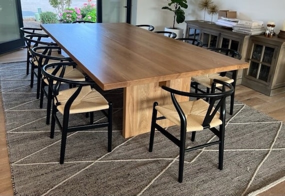 Thick Wood Pedestal Dining Table with Black Wishbone Chairs