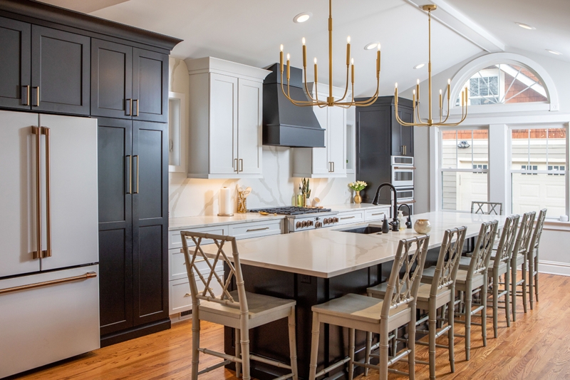 Transitional Kitchen Island with Gold Tiered Chandeliers and Bamboo Stools