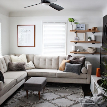 Tufted Back Sectional Sofa with Diamond Pattern Rug & Floating Shelves